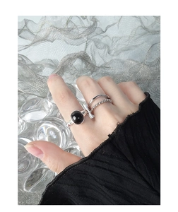 Close-up of minimalist S925 silver rings with black agate stone in stackable style