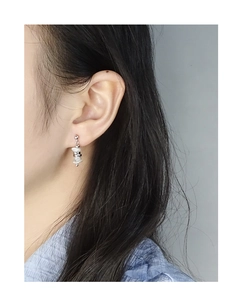 Close-up of S925 silver irregular baroque pearl drop earrings worn by a model