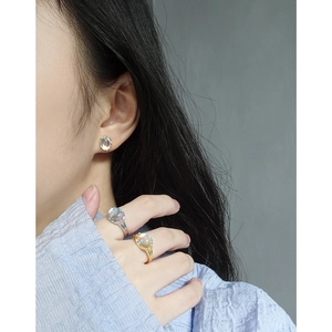 Minimalist S925 silver moonstone earrings and rings set shown on model in soft lighting