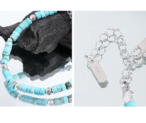 Detail of S925 sterling silver lobster clasp and turquoise beaded bracelet on a dark base
