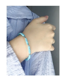 Detail of S925 silver beaded bracelet with turquoise stones on model wrist