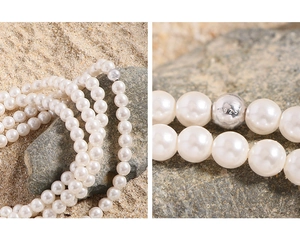 Macro view of S925 hallmark on a premium layered white pearl necklace clasp
