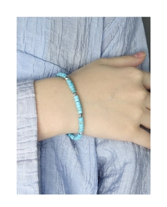 Detail of turquoise beaded bracelet with silver spacers on woman's wrist