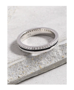 Macro shot of S925 sterling silver ring with zircon inlay and black enamel on grey stone