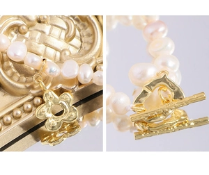 Macro detail of S925 sterling silver toggle clasp and flower pendant on pearl necklace