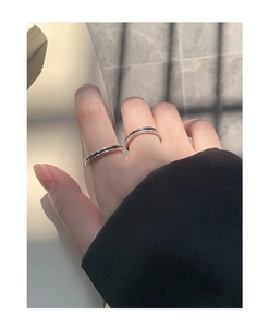Close-up of minimalist S925 silver ring set with textured band and zircon inlay