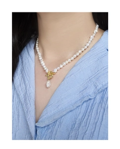 Detailed view of Baroque pearl necklace with golden OT buckle on a model's neck