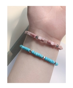 Close-up of S925 sterling silver beaded bracelet set with pink and turquoise stones