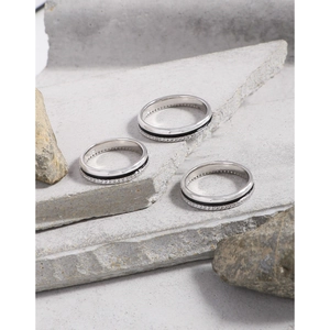 Minimalist S925 sterling silver rings set with black enamel and zircon on grey stone slabs