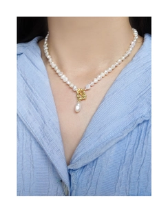 Baroque pearl necklace with gold OT clasp and drop pendant on a model's neck
