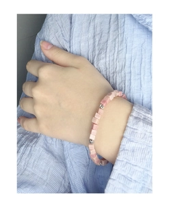 Close-up of pink square rhodochrosite and S925 silver beads bracelet on a wrist