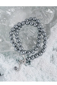 Detail of double-layer grey pearl necklace with S925 silver clasp on ice background