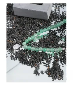 Detailed view of S925 silver necklace with green beads and a teardrop zircon pendant