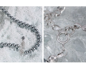 Close-up of S925 sterling silver lobster clasp and grey pearl necklace details