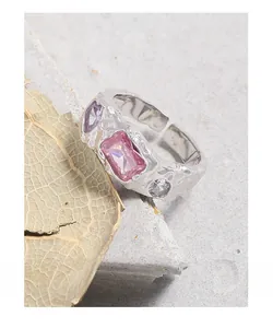 Detail of silver S925 ring featuring pink rectangular zircon and textured lava finish