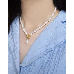 Baroque pearl necklace with gold OT buckle and teardrop pearl pendant on a model
