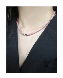 Close-up of S925 silver beaded necklace with pink rhodochrosite stones on black suit