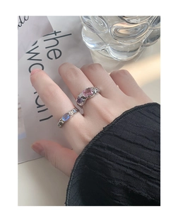 Detail of S925 silver rings with lava texture and colorful inlaid zircons on hand