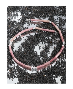 Macro shot of S925 silver beaded necklace with pink rhodochrosite stones and metal spacers