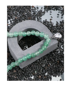Close-up of green aventurine beaded bracelet featuring a sparkling heart zircon charm