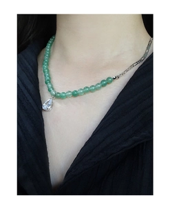 Macro detail of S925 silver necklace with green aventurine beads and drop pendant
