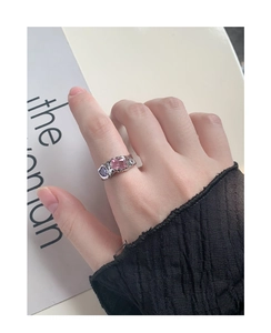Detail of S925 silver ring featuring wrinkled texture with pink and purple gemstones