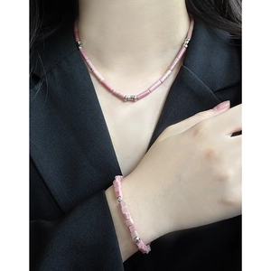 Elegant S925 silver necklace and bracelet set with pink rhodochrosite beads on black suit