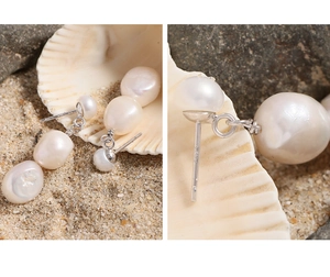 Detail of S925 sterling silver stamp and natural baroque pearls on a beach setting