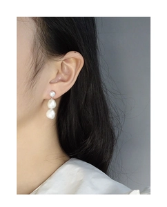 Close-up of three natural Baroque pearls vertically aligned on long S925 silver earrings