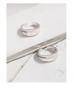 Macro shot of S925 sterling silver wide ring with irregular wavy texture on stone