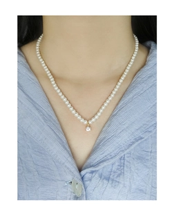 Elegant S925 silver pearl necklace with a sparkling cubic zirconia pendant on neck