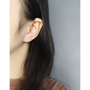 S925 sterling silver bow knot stud earrings with zircons shown on a model