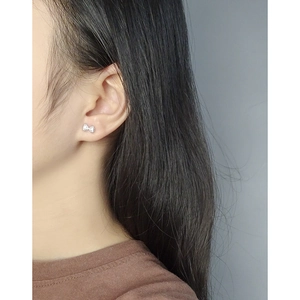 Elegant S925 silver bow stud earrings with sparkling cubic zirconia on female model