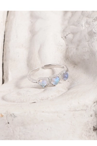 Detailed shot of S925 silver ring with textured band and three moonstone hearts