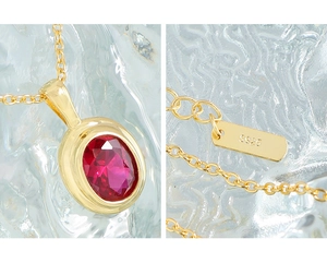 Macro detail of red oval zircon pendant on S925 sterling silver chain with hallmark