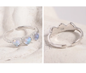 Macro detail of S925 sterling silver ring with blue heart moonstones and textured band