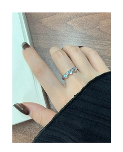Detailed view of S925 silver ring featuring three heart-shaped moonstones on a model hand