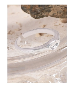 Macro shot of minimalist S925 sterling silver ring with irregular mirror-like texture