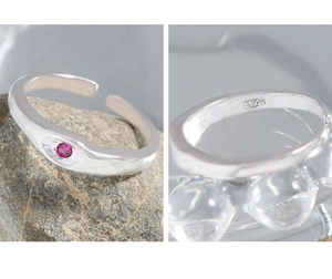 Detail view of S925 sterling silver ring featuring a hammered texture and magenta zircon