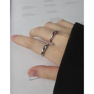 Minimalist S925 silver liquid metal style rings set with zircon stones on a magazine background