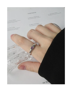 Close-up of S925 silver ring featuring an irregular design with a purple zircon stone