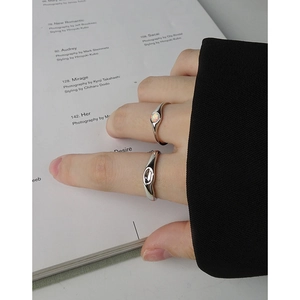 Minimalist S925 silver ring set with opal gemstone and irregular band on a magazine background