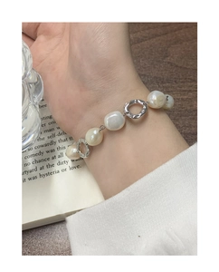 Close-up of a S925 silver bracelet featuring natural baroque pearls and wavy metal rings