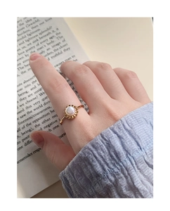 Detailed macro view of S925 silver flower bud pearl ring with elegant gold finish plating