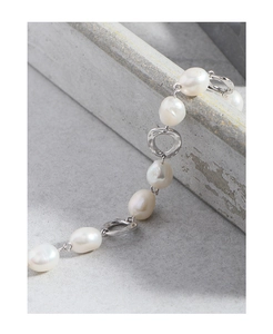 Close-up of S925 sterling silver chain bracelet with natural baroque pearls