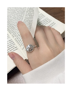 Detailed view of an S925 sterling silver conch-shaped open ring worn during reading