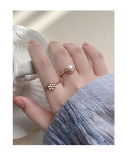 Detail of S925 silver flower and pearl rings worn during afternoon tea setting