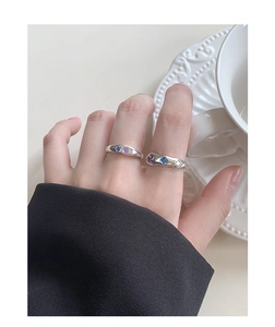 Detail of silver S925 rings set with vibrant cubic zirconia on model's hand