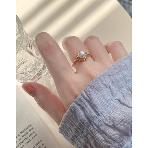 French style S925 silver flower pearl open ring on model finger with soft lighting