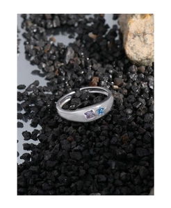 Detail of silver S925 ring with square purple gemstone and blue star accent
